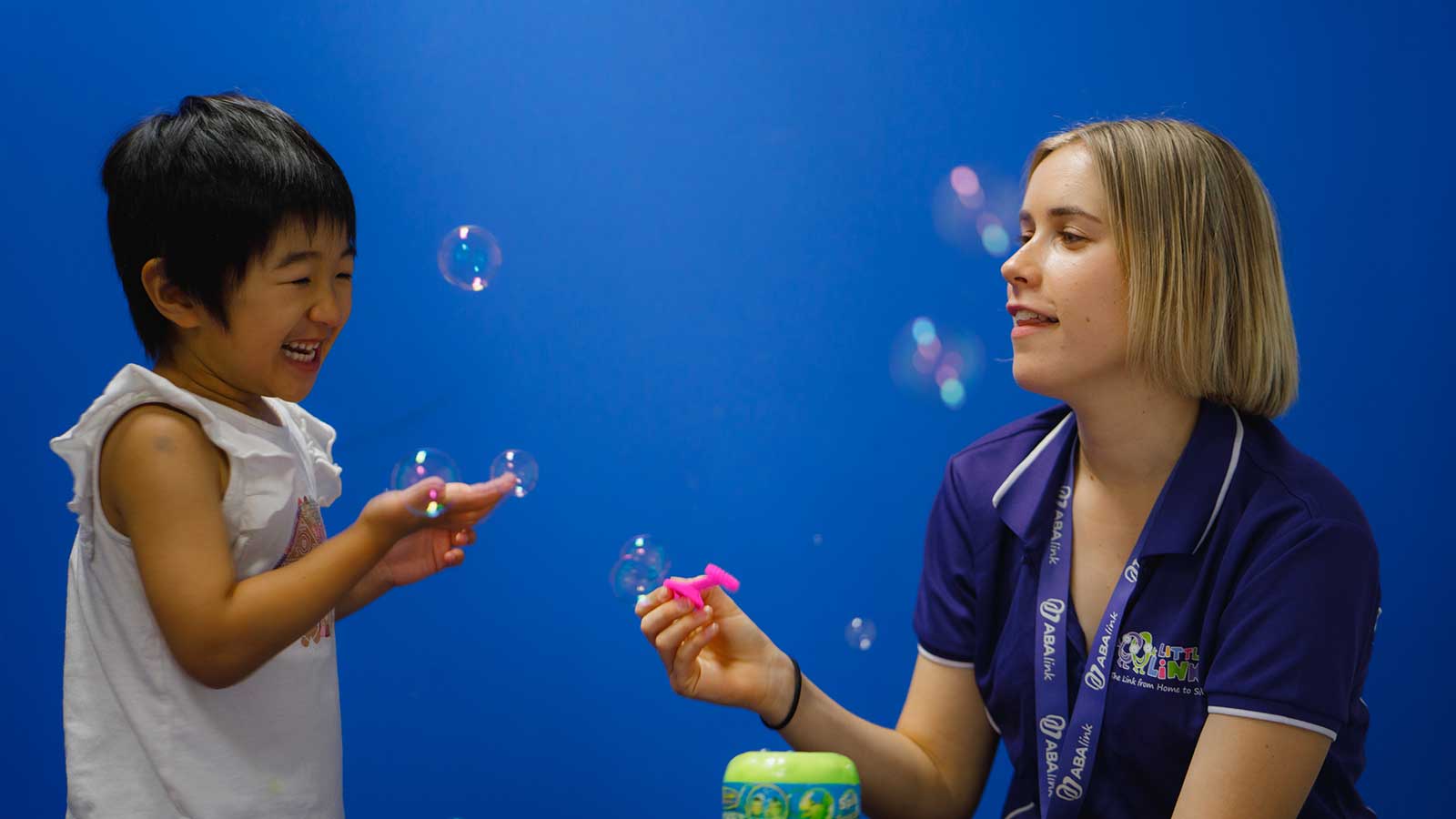 Annike with Little Girl Blowing Bubbles